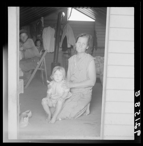 Untitled photo, possibly related to: Tulare County, Farm Security Administration (FSA) camp. Migrant mother and child at doorway of steel shelter