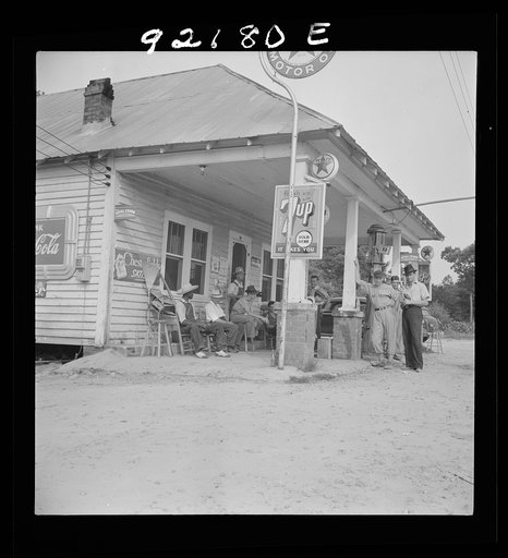 Untitled photo, possibly related to: Rural filling station becomes community center and general grounds for loafing. The men in baseball suits are on a local team which will play a game nearby. The team is called the Cedargrove Team. Fourth of July, Near Chapel Hill, North Carolina