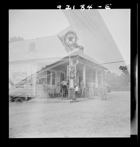 Untitled photo, possibly related to: Rural filling station becomes community center and general grounds for loafing. The men in baseball suits are on a local team which will play a game nearby. The team is called the Cedargrove Team. Fourth of July, Near Chapel Hill, North Carolina