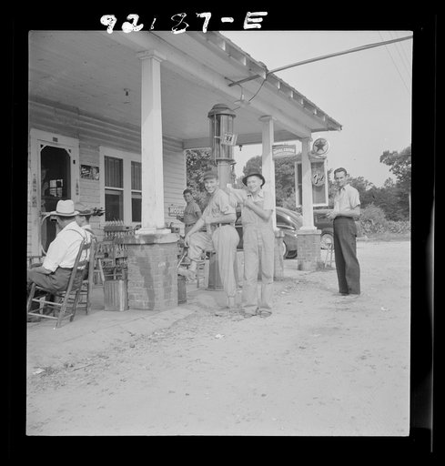 Untitled photo, possibly related to: Rural filling station becomes community center and general grounds for loafing. The men in baseball suits are on a local team which will play a game nearby. The team is called the Cedargrove Team. Fourth of July, Near Chapel Hill, North Carolina