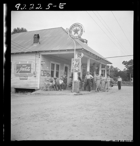 Untitled photo, possibly related to: Rural filling station becomes community center and general grounds for loafing. The men in baseball suits are on a local team which will play a game nearby. The team is called the Cedargrove Team. Fourth of July, Near Chapel Hill, North Carolina