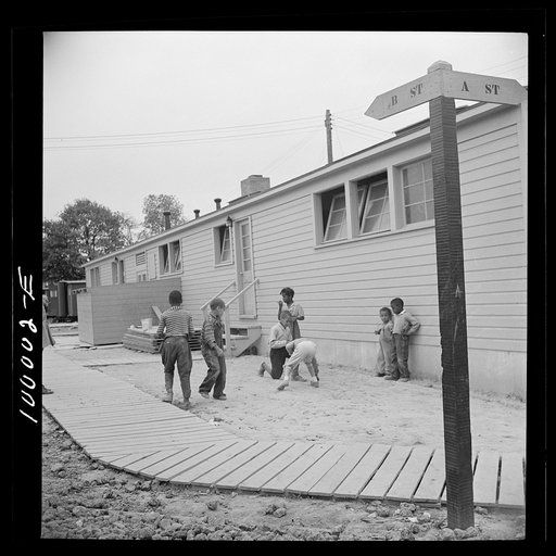 Arlington, Virginia. FSA (Farm Security Administration) trailer camp project for Negroes. Children playing marbles outside the community building