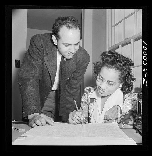 Arlington, Virginia. FSA (Farm Security Administration) trailer camp project for Negroes. Manager of the project going over rental plan with his secretary