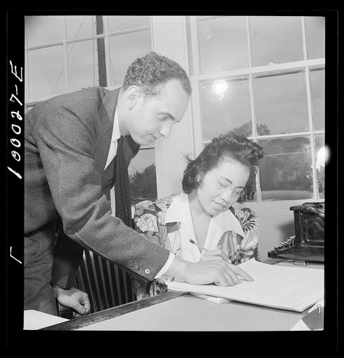 Untitled photo, possibly related to: Arlington, Virginia. FSA (Farm Security Administration) trailer camp project for Negroes. Manager of the project going over rental plan with his secretary