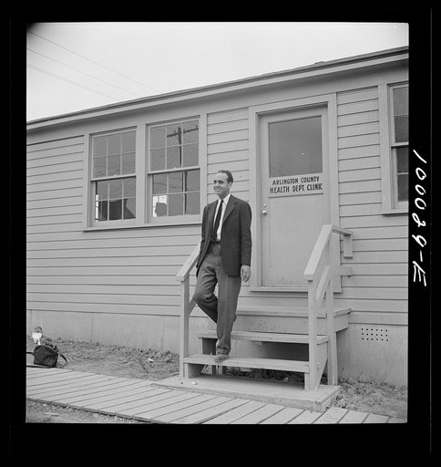 Untitled photo, possibly related to: Arlington, Virginia. FSA (Farm Security Administration) trailer camp project for Negroes. Manager of the project outside the clinic in the community building