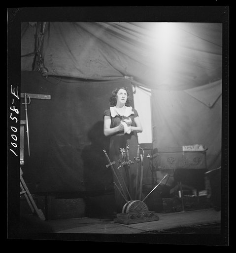 Untitled photo, possibly related to: Norfolk, Virginia. Sword swallower in a travelling railroad show resting between acts