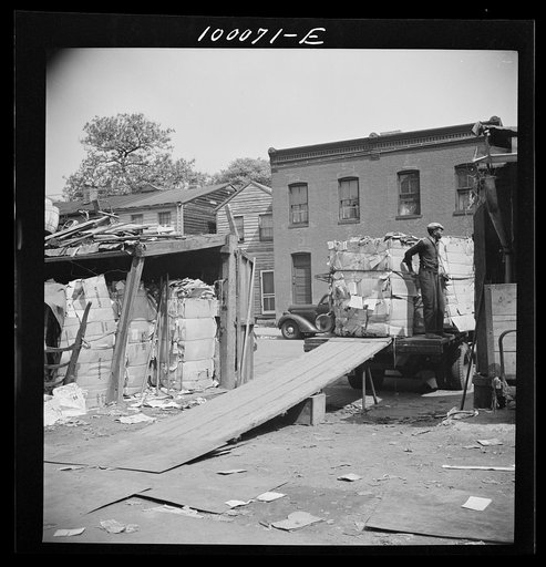 Washington, D.C. Salvage drive, Victory Program. Bales of scrap paper stored in yard of District retail junk company are loaded onto truck headed for the wholesaler