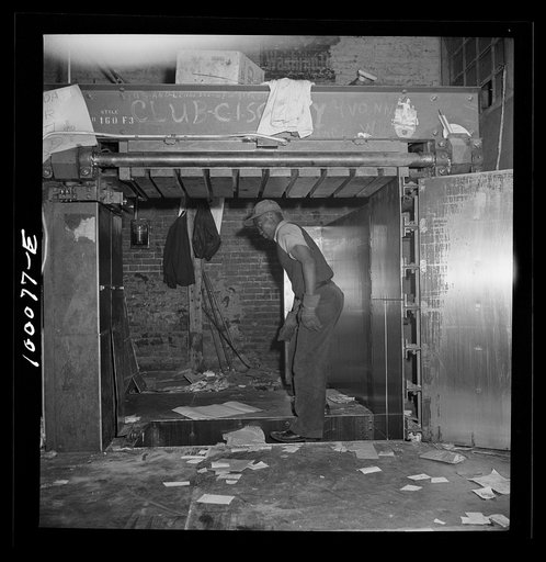 Washington, D.C. Scrap salvage campaign, Victory Program. Stamping on scrap paper which has been loaded into a hydraulic press at a retail junkyard