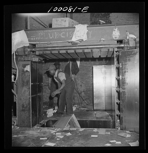 Untitled photo, possibly related to: Washington, D.C. Scrap salvage campaign, Victory Program. Stamping on scrap paper which has been loaded into a hydraulic press at a retail junkyard