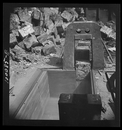 Washington, D.C. Scrap salvage campaign, Victory Program. Powerful hydraulic press for pressing metal scrap into blocks in the yard of a wholesale junk company