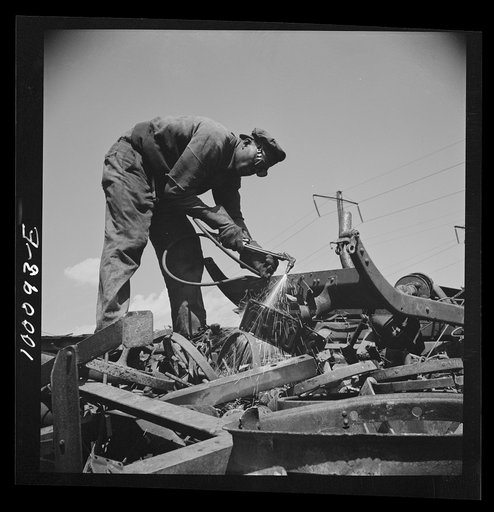 Washington, D.C. Scrap salvage campaign, Victory Program. Using acetylene torch to break up metal scrap before shipment from a wholesale junk yard