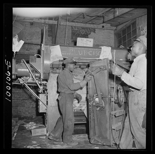 Washington, D.C. Scrap salvage campaign, Victory Program. Opening up hydraulic press showing paper ready for baling