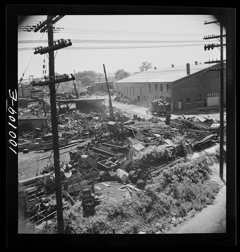 Washington, D.C. Scrap salvage campaign, Victory Program. Wholesale junkyard beside siding in rear background. Truck in right foreground is being weighed on platform scale before unloading