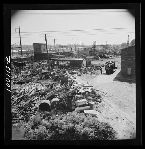Untitled photo, possibly related to: Washington, D.C. Scrap salvage campaign, Victory Program. Wholesale junkyard beside siding in rear background. Truck in right foreground is being weighed on platform scale before unloading