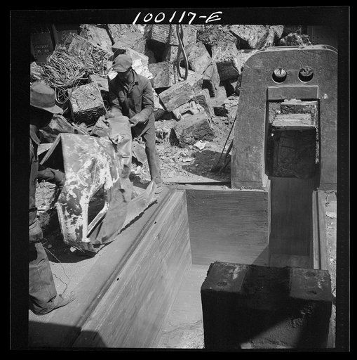 Untitled photo, possibly related to: Washington, D.C. Scrap salvage campaign, Victory Program. Powerful hydraulic press for pressing metal scrap into blocks in the yard of a wholesale junk company
