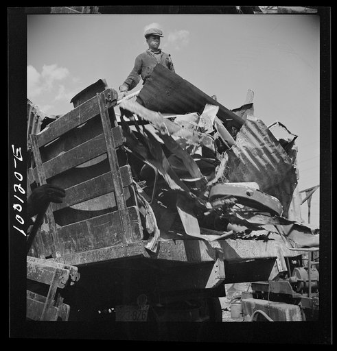 Untitled photo, possibly related to: Washington, D.C. Scrap salvage campaign, Victory Program. Unloading metal scrap from a truck at a wholesale junkyard