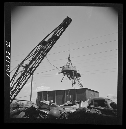 Washington, D.C. Scrap salvage campaign, Victory Program. Electro-magnet loads metal scrap onto freight car in wholesale junkyard