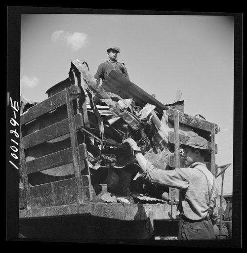 Untitled photo, possibly related to: Washington, D.C. Scrap salvage campaign, Victory Program. Unloading metal scrap from a truck at a wholesale junkyard
