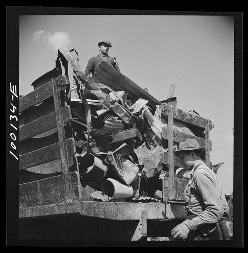 Untitled photo, possibly related to: Washington, D.C. Scrap salvage campaign, Victory Program. Unloading metal scrap from a truck at a wholesale junkyard