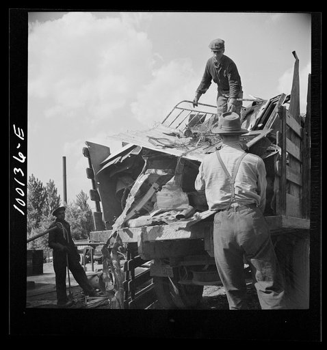 Untitled photo, possibly related to: Washington, D.C. Scrap salvage campaign, Victory Program. Unloading metal scrap from a truck at a wholesale junkyard