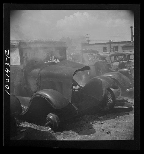 Untitled photo, possibly related to: Washington, D.C. Scrap salvage campaign, Victory Program. After saleable parts are removed from old cars, the cars are burned in order to strip them of useless materials and to obtain metal skeleton for scrap