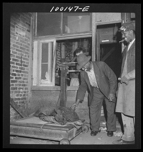 Washington, D.C. Scrap salvage campaign, Victory Program. Scrap rags being weighed before their purchase by a retail junk dealer