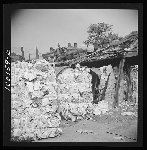 Washington, D.C. Scrap salvage campaign, Victory Program. Stacking bales of pressed paper in a retail junkyard