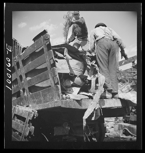 Untitled photo, possibly related to: Washington, D.C. Scrap salvage campaign, Victory Program. Unloading metal scrap from a truck at a wholesale junkyard