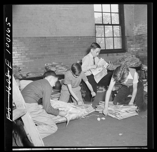 Untitled photo, possibly related to: Washington, D.C. Scrap salvage campaign, Victory Program. Tying up bundles of scrap paper at public school. A company truck collects once a week from each school in a truck