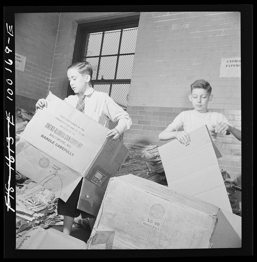 Washington, D.C. Scrap salvage campaign, Victory Program. Washington schoolchildren fold cartons so that they will pack flat and can be tied in bundles which are collected by paper company truck once a week
