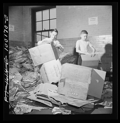 Untitled photo, possibly related to: Washington, D.C. Scrap salvage campaign, Victory Program. Washington schoolchildren fold cartons so that they will pack flat and can be tied in bundles which are collected by paper company truck once a week