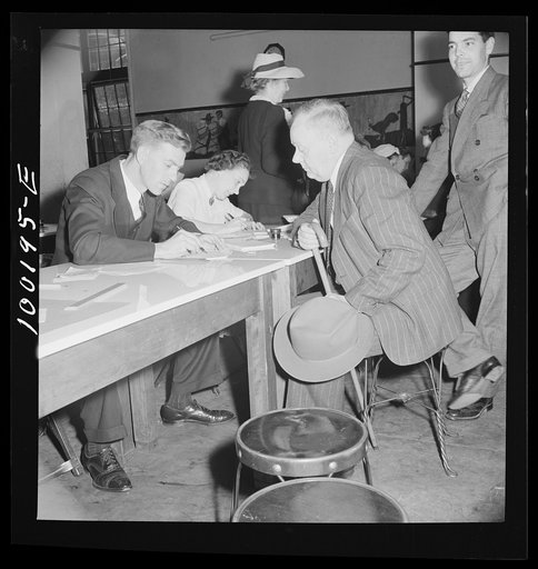 Apparently prosperous gentleman gives his name and address to school teacher who fills out his ration card--one pound every two weeks