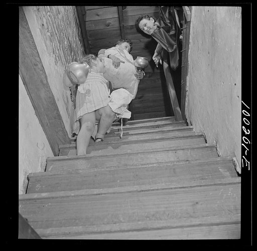 Untitled photo, possibly related to: Washington, D.C. Scrap salvage campaign, Victory Program. These children are bringing piles of rags and metal objects down from an attic to contribute to the scrap collecting campaign