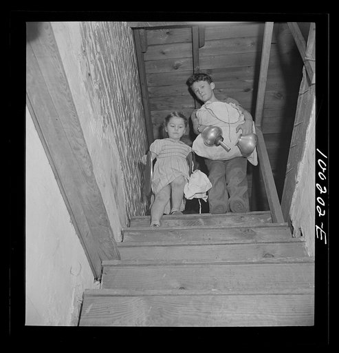 Washington, D.C. Scrap salvage campaign, Victory Program. These children are bringing piles of rags and metal objects down from an attic to contribute to the scrap collecting campaign