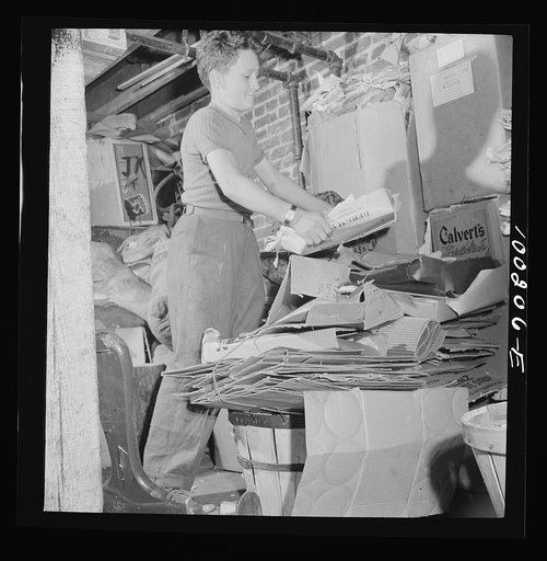 Washington, D.C. Scrap salvage campaign, Victory Program. This boy keeps stacks of paper, metal and rags in his cellar, ready for a junk dealer to pick up