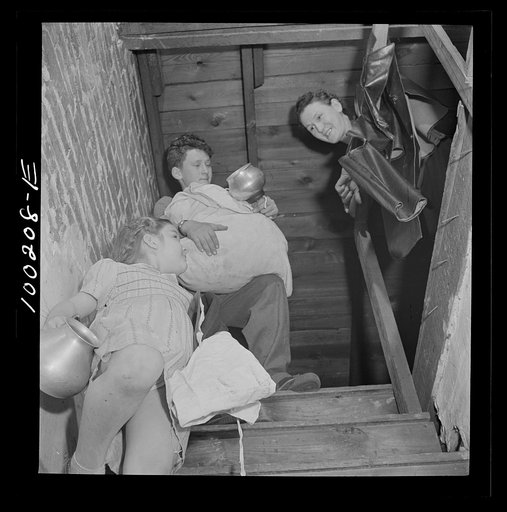 Untitled photo, possibly related to: Washington, D.C. Scrap salvage campaign, Victory Program. These children are bringing piles of rags and metal objects down from an attic to contribute to the scrap collecting campaign