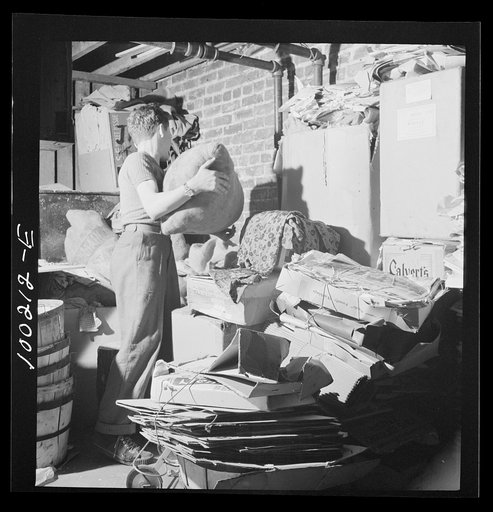 Untitled photo, possibly related to: Washington, D.C. Scrap salvage campaign, Victory Program. This boy keeps stacks of paper, metal and rags in his cellar, ready for a junk dealer to pick up