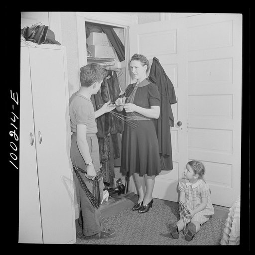 Washington, D.C. Scrap salvage campaign, Victory Program. This mother has found in her closet some metal hangers, which her son will stack in the cellar for contribution in the scrap collecting campaign