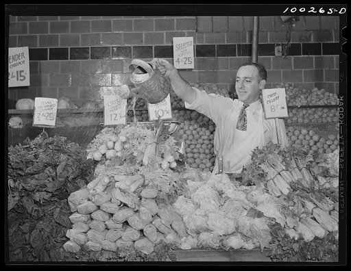 Washington, D.C. Watering vegetables to keep them fresh in the Giant Food shopping center on Wisconsin Avenue