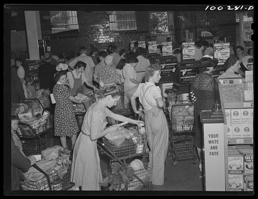 Washington, D.C. Checking over purchases while waiting in line to pay the cashier at the Giant Food shopping center on Wisconsin Avenue
