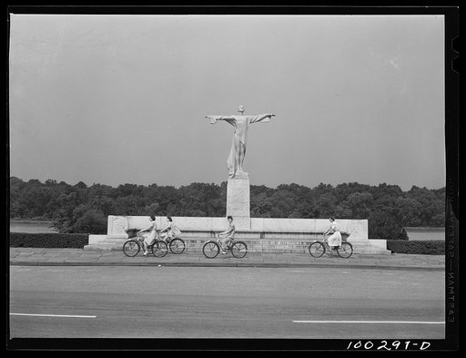 Washington, D.C. Bicycling on Sunday in East Potomac Park, in front of the statue erected to the memory of the victims of the Titanic disaster