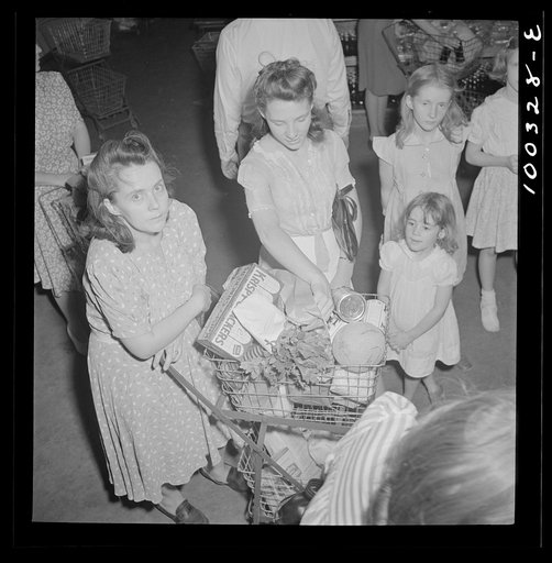 Untitled photo, possibly related to: Washington, D.C. Customers getting out their sugar ration cards in the Giant Food shopping center on Wisconsin Avenue