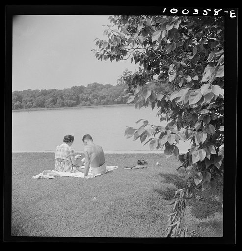 Washington, D.C. Reading beside the Potomac River in East Potomac park on Sunday
