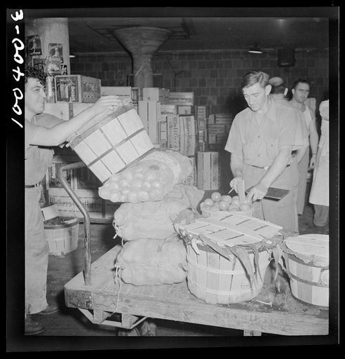 Washington, D.C. District grocery store warehouse on 4th Street S.W. Each store's order is loaded onto a small truck and checked, first by a foreman, again by a checker at the door before being loaded onto a truck. Produce department