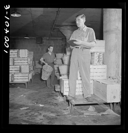 Washington, D.C. District grocery store warehouse on 4th Street S.W. Foreman calling out orders from the platform, which men are loading onto small trucks