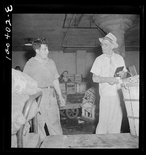 Untitled photo, possibly related to: Washington, D.C. District grocery store warehouse on 4th street S.W. Store owner kidding with the order foreman. There are 200 odd member stores in the District of Columbia