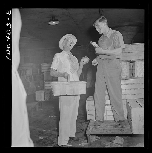 Washington, D.C. District grocery store warehouse on 4th street S.W. Store owner kidding with the order foreman. There are 200 odd member stores in the District of Columbia