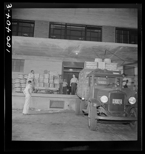 Washington, D.C. District grocery store warehouse on 4th Street S.W. Farmers bringing their produce in trucks, between two and five a.m. The trucks are unloaded on the outdoor platform