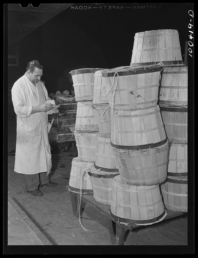 Washington, D.C. District grocery store warehouse on 4th Street S.W. Assistant head of the produce department checking over a shipment of spinach which has just been unloaded