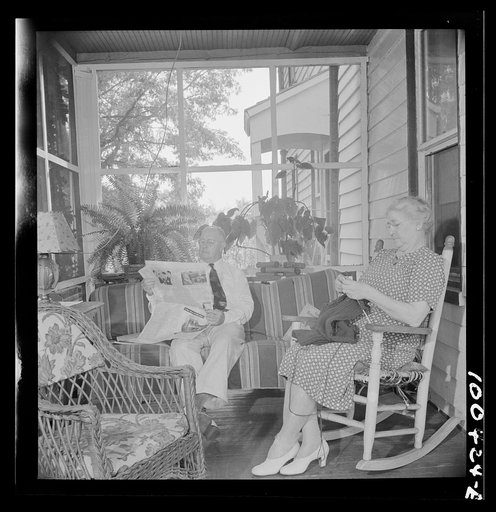 Mechanicsville, Maryland. Mr. and Mrs. Charles Herbert sitting on the porch of the home which he helped to build when he first came here thirty-six years ago to be a express agent. Mrs. Herbert is the town dressmaker